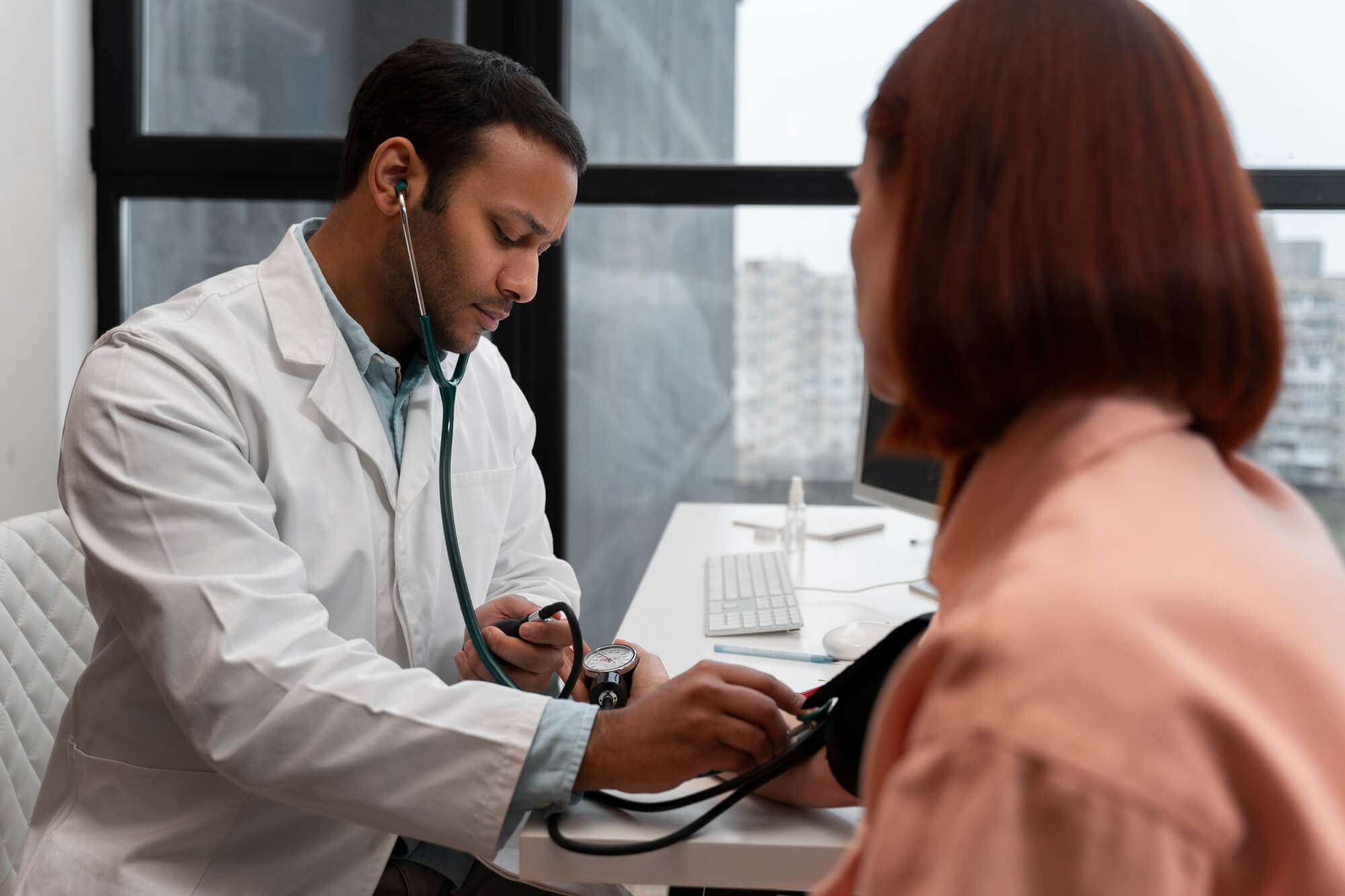 2150165502 (1) Doctor in office preparing for health assessment